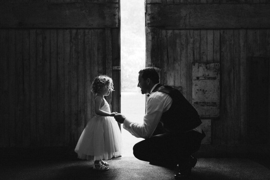 Groom and niece at a barn wedding at the Red Barn